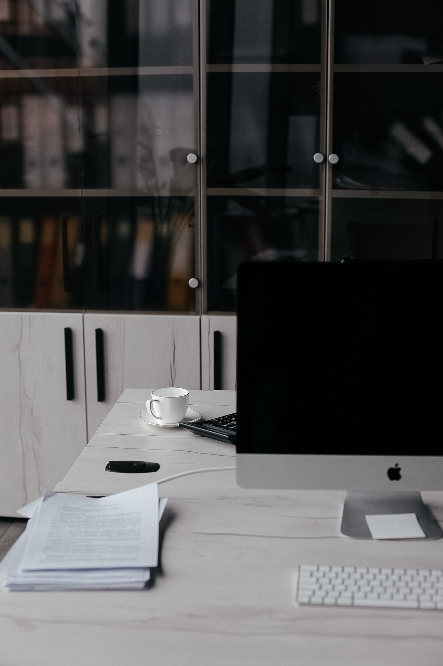 Clean campaign workspace with desktop computer, documents, and coffee